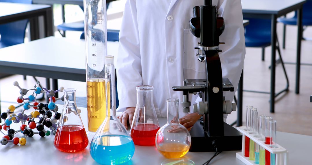 Scientist Conducting Experiment in Laboratory with Microscope and Chemical Glassware - Free Images, Stock Photos and Pictures on Pikwizard.com