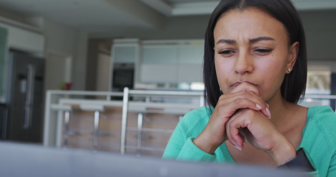 Focused Woman Analyzing Data on a Laptop in Modern Office