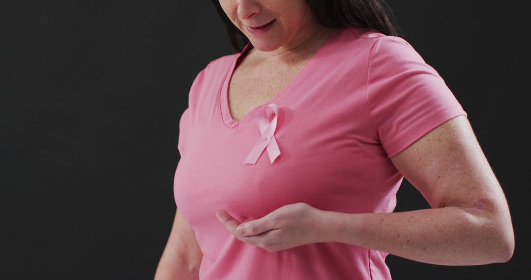 Woman Wearing Pink Ribbon Focusing on Breast Health Awareness - Free Images, Stock Photos and Pictures on Pikwizard.com