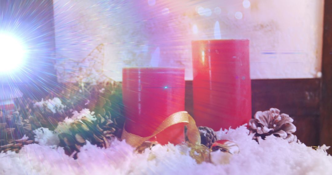Festive Red Candles with Snow and Pinecones Illuminating Holiday Spirit