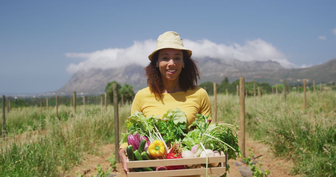 Smiling Female Farmer Holding Box of Fresh Organic Vegetables - Free Images, Stock Photos and Pictures on Pikwizard.com