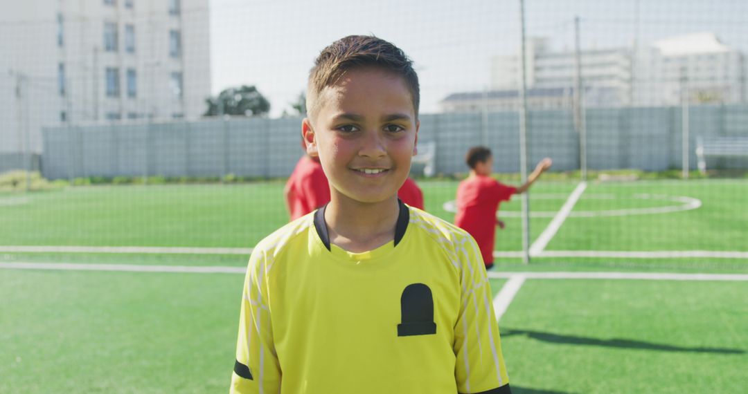 Smiling Young Boy in Yellow Jersey on Soccer Field - Free Images, Stock Photos and Pictures on Pikwizard.com