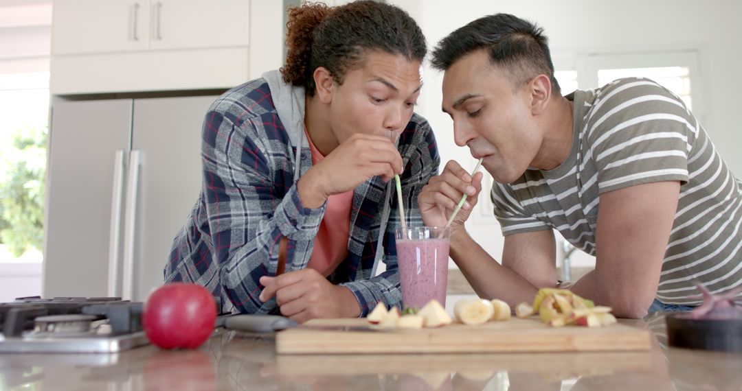 Happy Couple Sharing Smoothie at Home