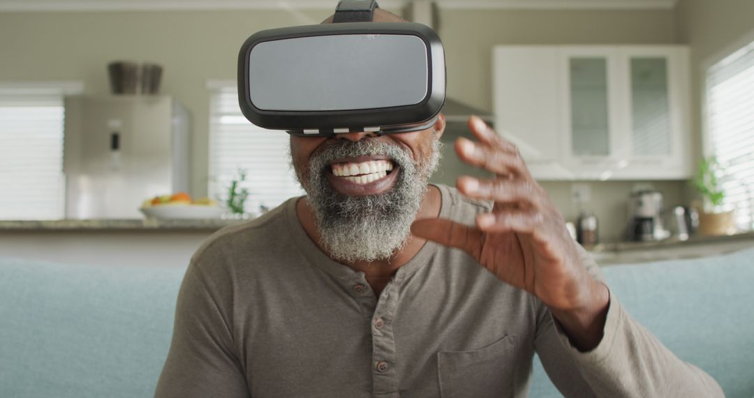 Senior Man Experiencing Virtual Reality With Headset in Modern Living Room - Free Images, Stock Photos and Pictures on Pikwizard.com