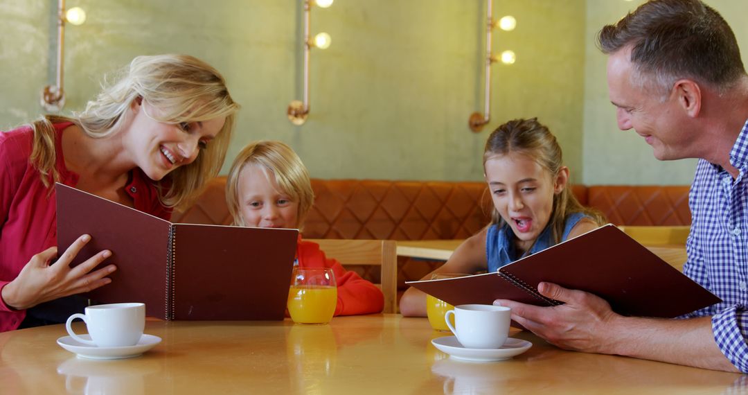 Happy Family Reading Menus Together in Coffee Shop - Free Images, Stock Photos and Pictures on Pikwizard.com