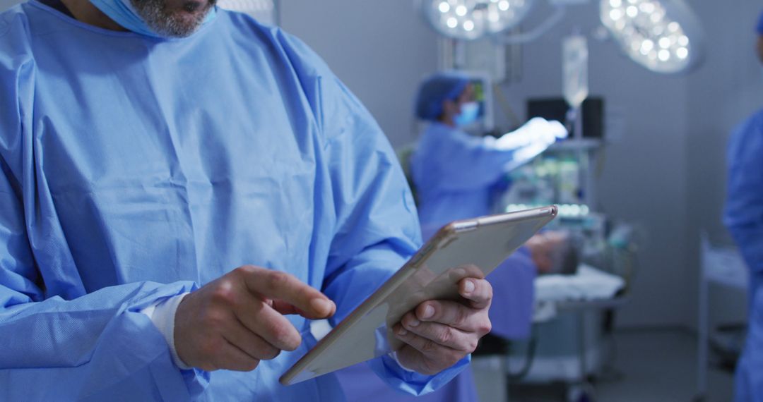 Doctors Using Tablet in Modern Surgery Operating Room - Free Images, Stock Photos and Pictures on Pikwizard.com