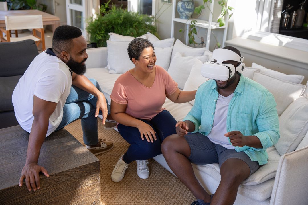 Diverse Friends Having Fun with Virtual Reality Headset in Living Room