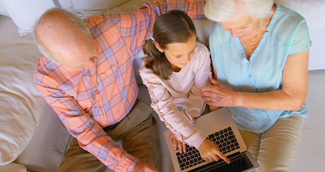 Grandparents and Granddaughter Using Laptop Together - Free Images, Stock Photos and Pictures on Pikwizard.com