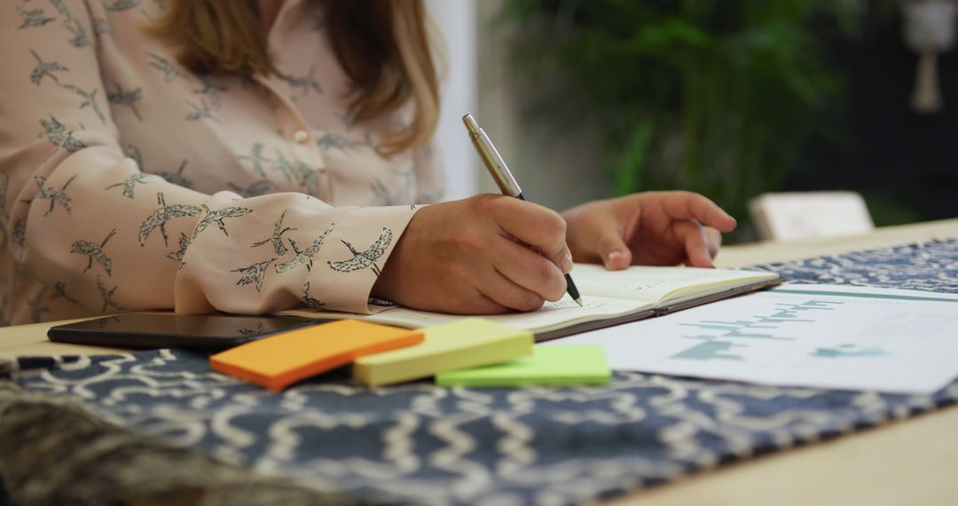 Woman Writing Notes at Desk with Sticky Notes and Phone - Free Images, Stock Photos and Pictures on Pikwizard.com