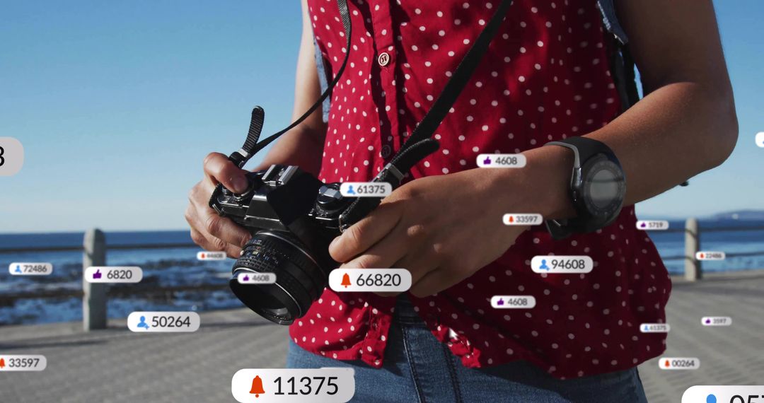 Photographer Adjusting DSLR with Floating Social Media Icons on Boardwalk
