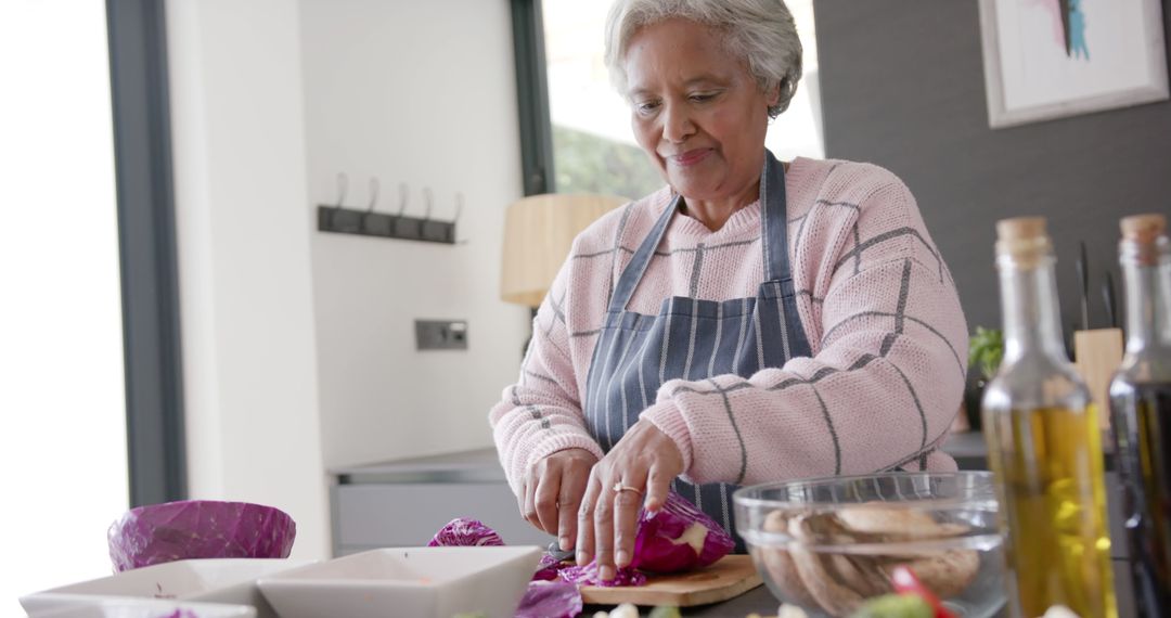 Senior Woman Slicing Vegetables in Modern Kitchen Smiling - Free Images, Stock Photos and Pictures on Pikwizard.com