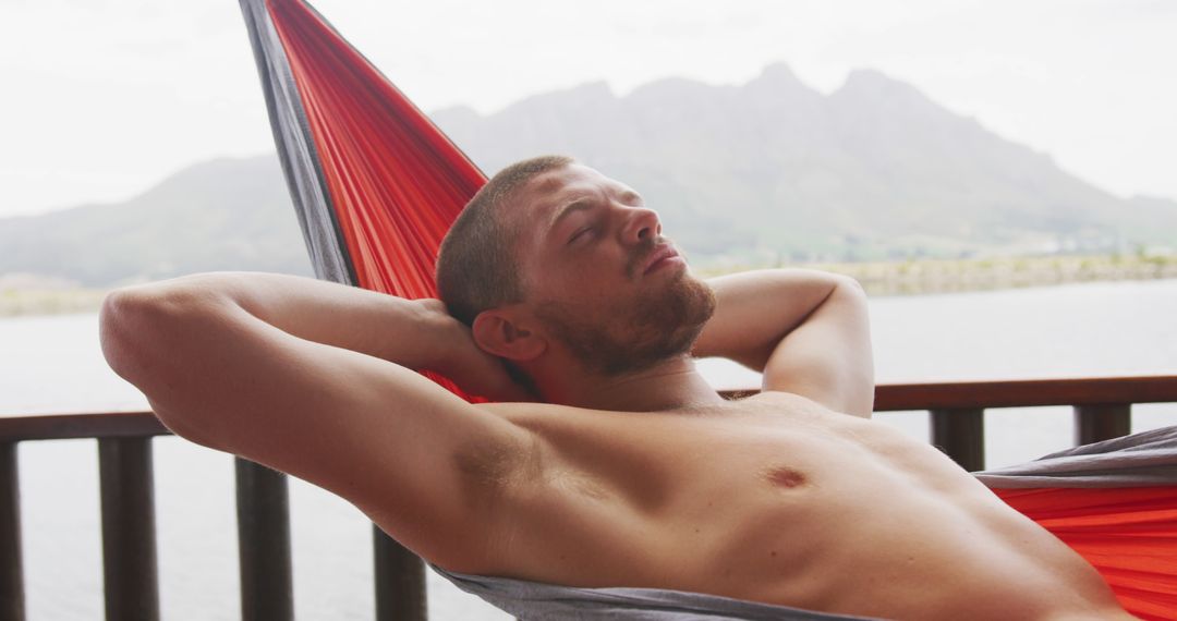 Man Relaxing in Hammock Overlooking Scenic Mountain Lake - Free Images, Stock Photos and Pictures on Pikwizard.com