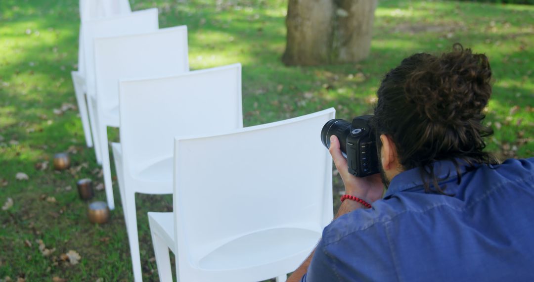 Photographer Preparing for Outdoor Event on Green Lawn - Free Images, Stock Photos and Pictures on Pikwizard.com