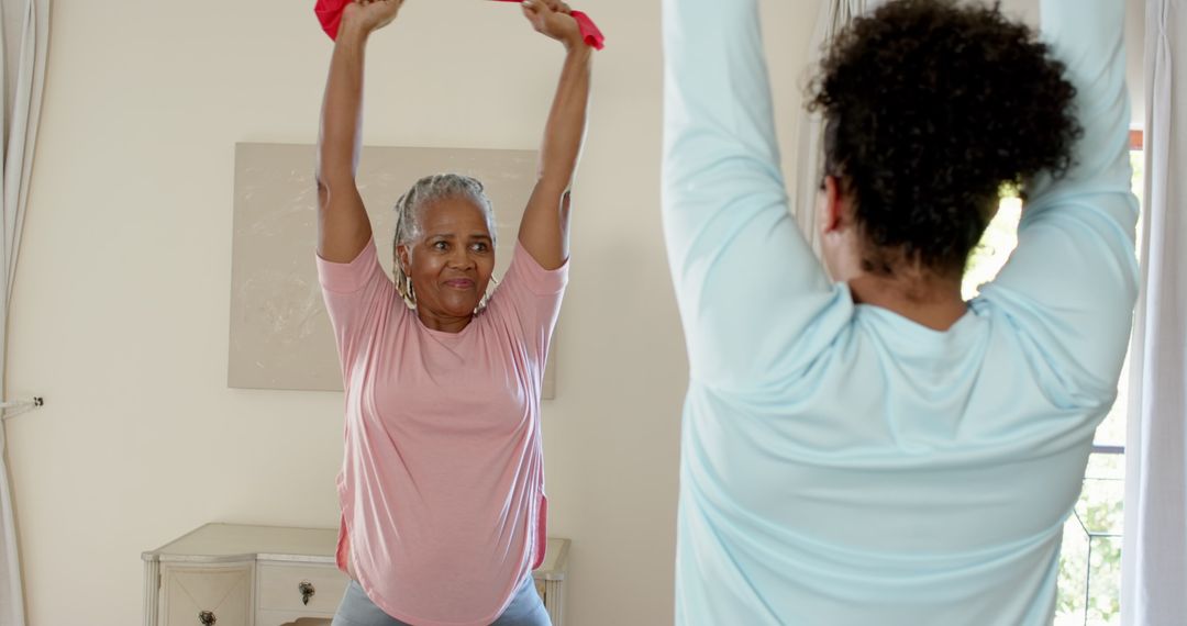 Energetic Senior Woman Exercising with Resistance Band at Home