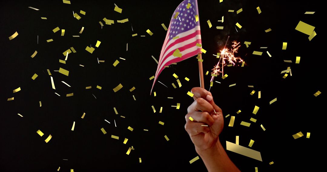 Hand Holding USA Flag and Sparkler Amid Golden Confetti