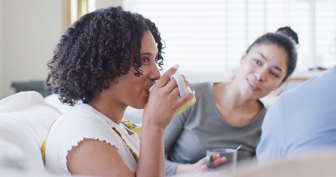 Two Women Relaxing and Drinking Tea on Couch - Free Images, Stock Photos and Pictures on Pikwizard.com