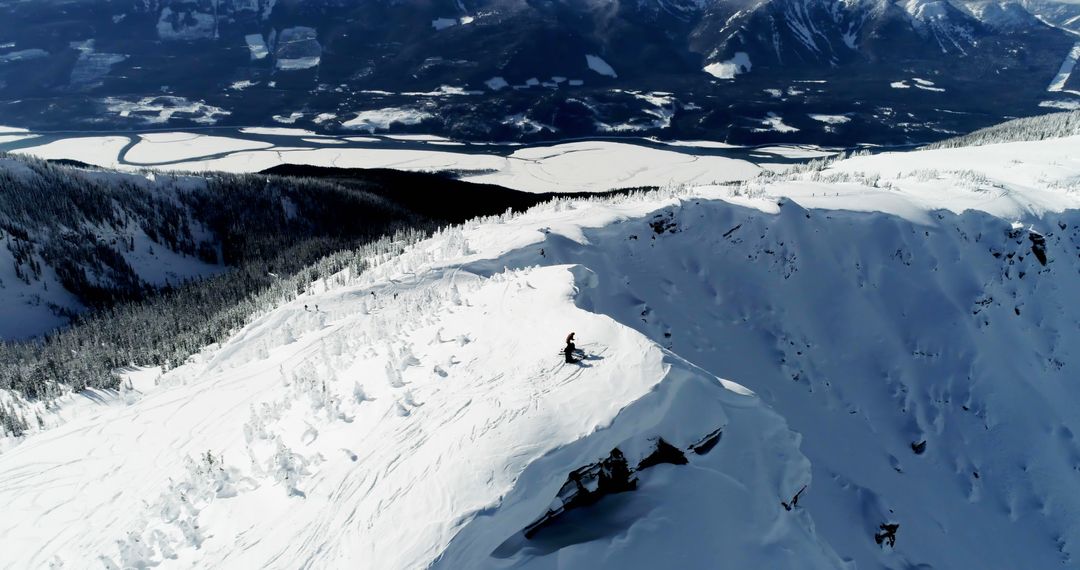 Aerial View of Skier on Snowy Mountain Peak - Free Images, Stock Photos and Pictures on Pikwizard.com