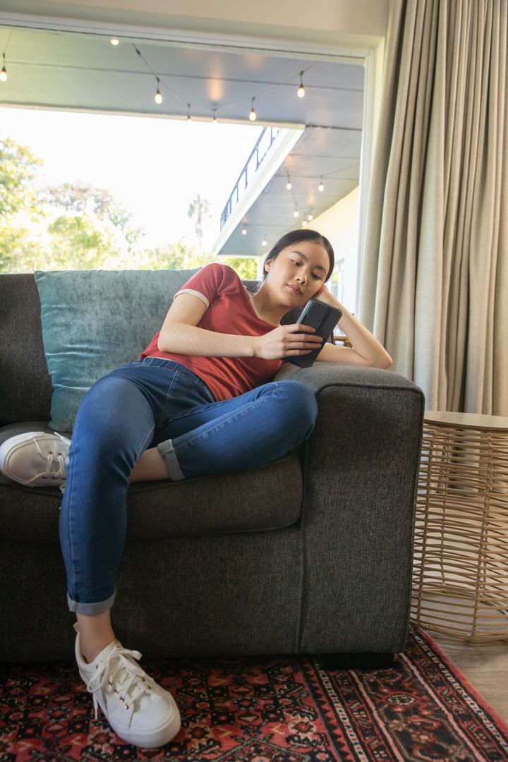 Casual Relaxation at Home with Smartphone in Hand