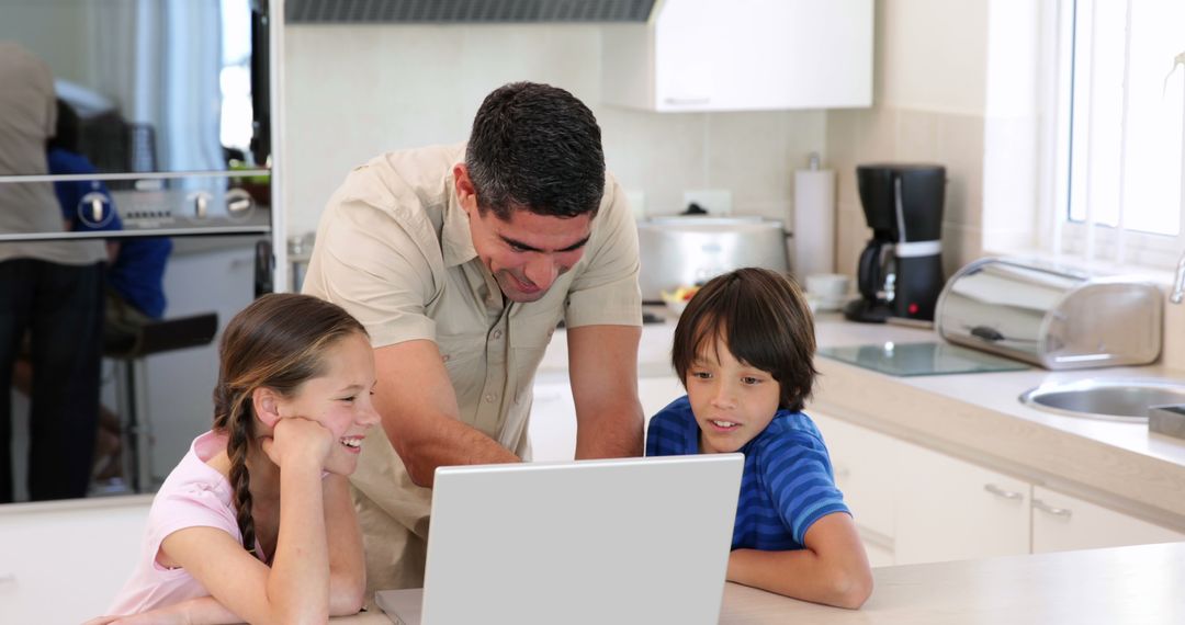 Father Teaching Children at Home Using Laptop in Modern Kitchen - Free Images, Stock Photos and Pictures on Pikwizard.com