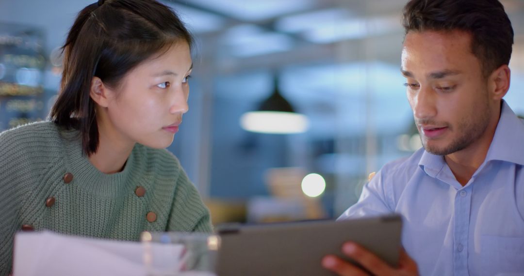 Diverse Colleagues Discussing Project on Tablet in Office