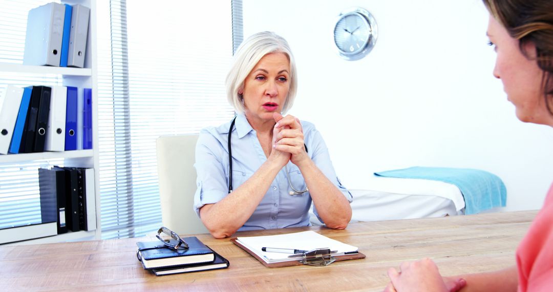 Senior Female Doctor Consulting Patient in Modern Office - Free Images, Stock Photos and Pictures on Pikwizard.com