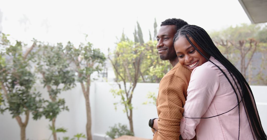 Happy Couple Embracing on Modern Terrace with Planters