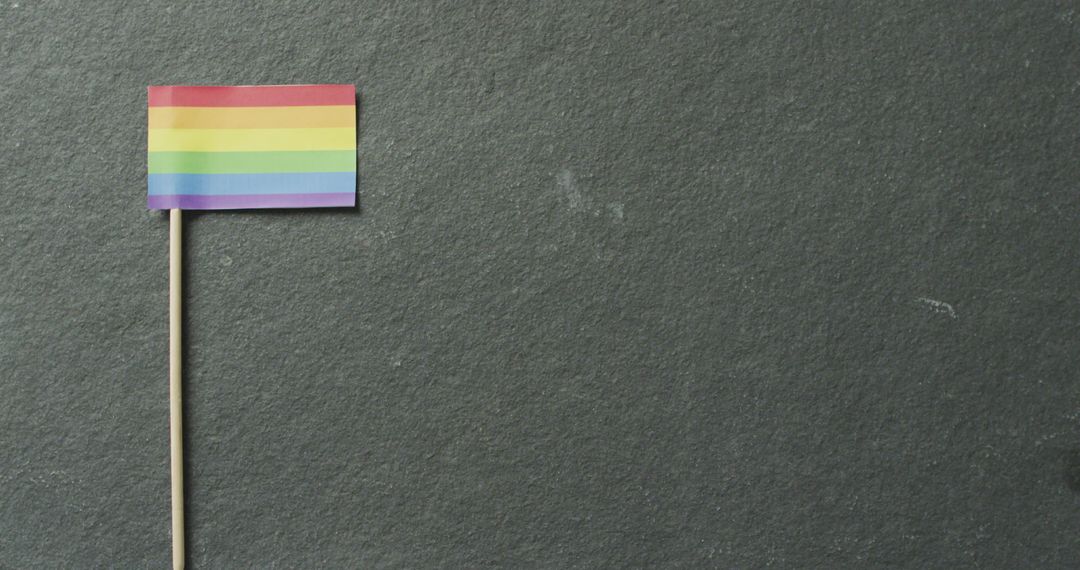Rainbow Flag Lying on White Background Symbolizing LGBTQ+ Pride and Rights - Free Images, Stock Photos and Pictures on Pikwizard.com