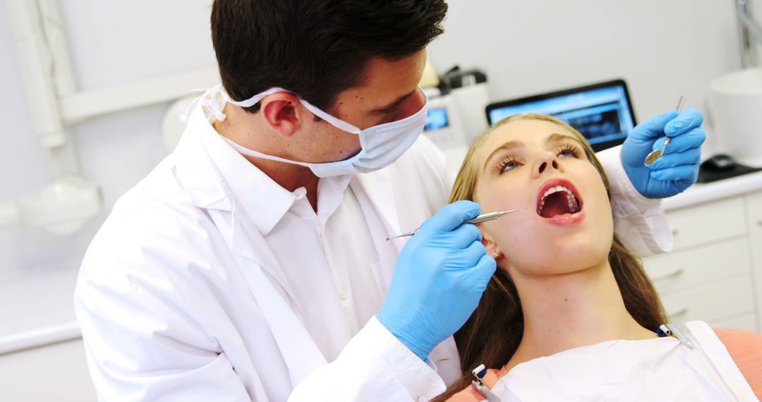 Dentist Examining Female Patient's Teeth in Modern Dental Clinic - Free Images, Stock Photos and Pictures on Pikwizard.com