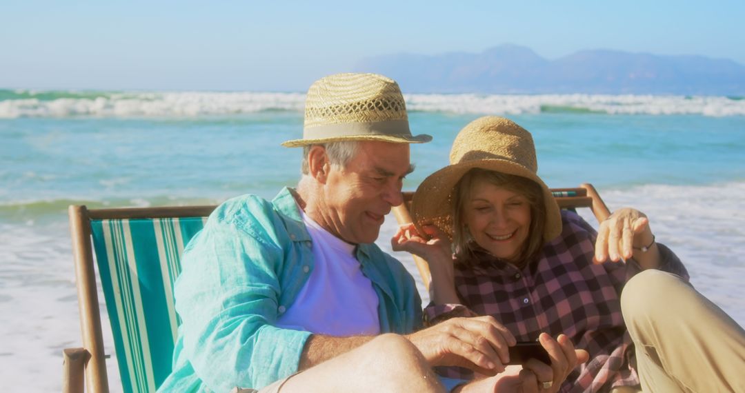 Senior Couple Relaxing and Taking Selfie on Beach Holiday