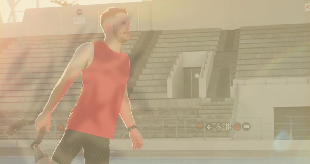 Athlete Stretching on Running Track in Bright Sunlight