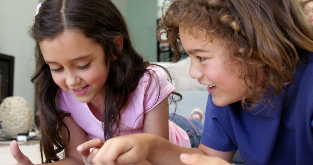 Two Happy Children Playing Games on Tablet at Home - Free Images, Stock Photos and Pictures on Pikwizard.com