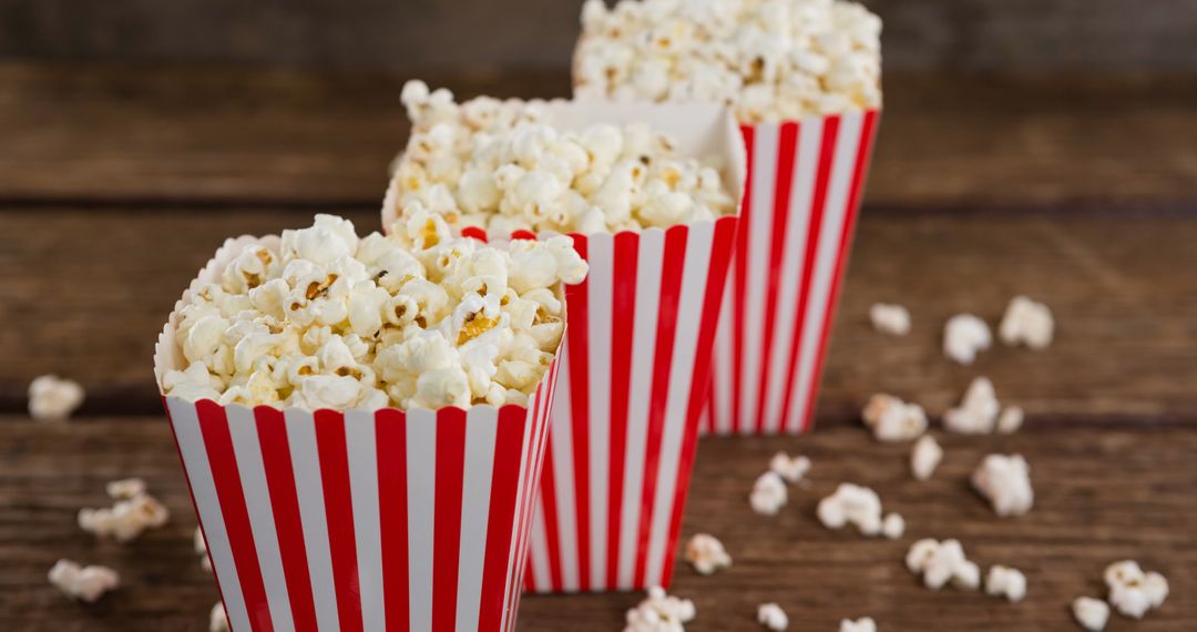 Delicious Popcorn in Red Striped Boxes on Wooden Table - Free Images, Stock Photos and Pictures on Pikwizard.com