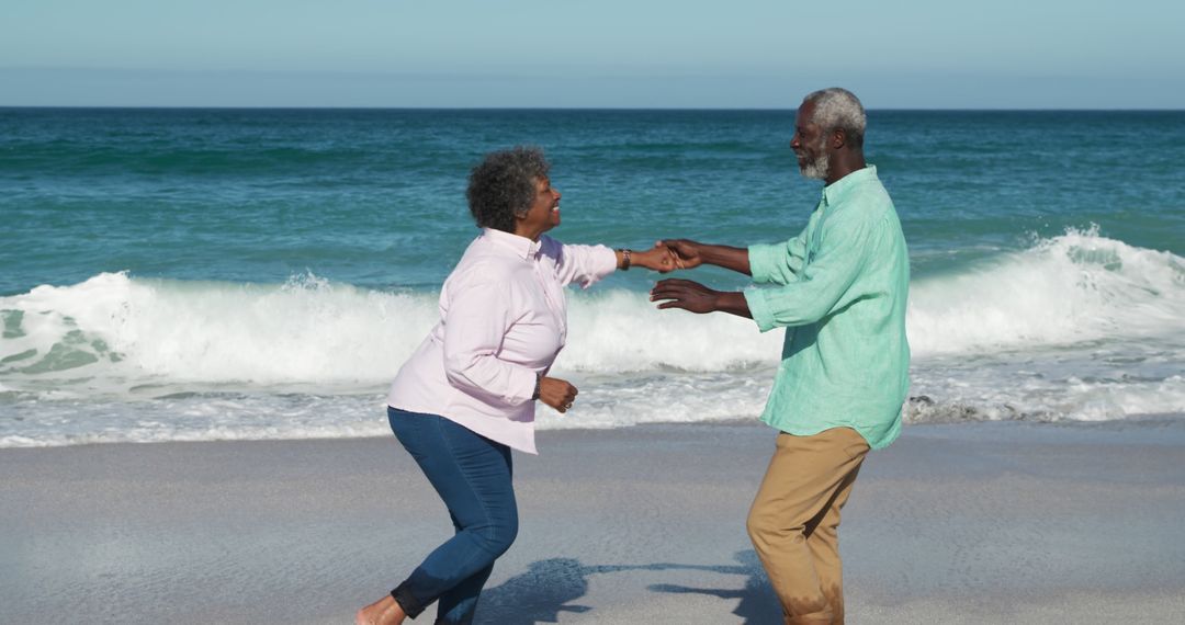 Senior Couple Dancing Playfully on Beach - Free Images, Stock Photos and Pictures on Pikwizard.com