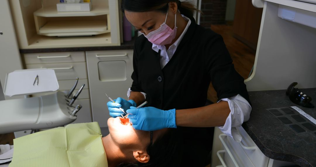 Dentist Treating Patient in Dental Clinic Exam Room - Free Images, Stock Photos and Pictures on Pikwizard.com