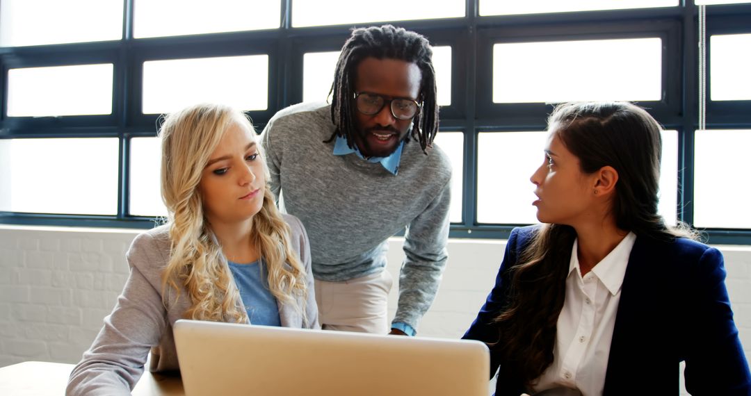 Diverse Team Collaborating on Business Project at Workspace