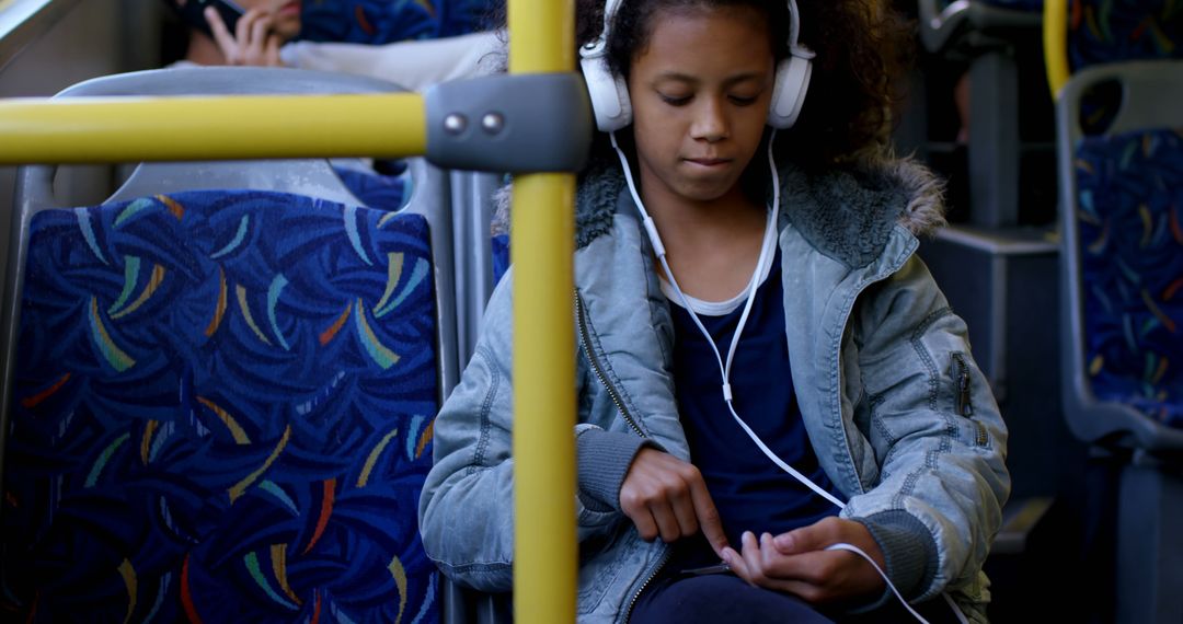 Young Girl Listening to Music on Bus Ride During Daytime - Free Images, Stock Photos and Pictures on Pikwizard.com