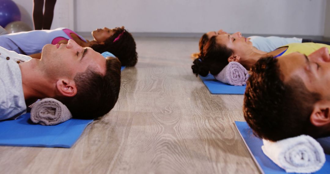 Group Relaxation Exercise Lying on Mats with Neck Support Towels - Free Images, Stock Photos and Pictures on Pikwizard.com