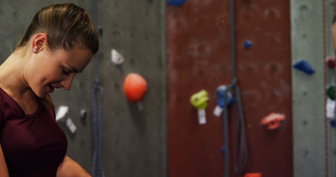 Young Woman Preparing for Indoor Rock Climbing at Gym - Free Images, Stock Photos and Pictures on Pikwizard.com