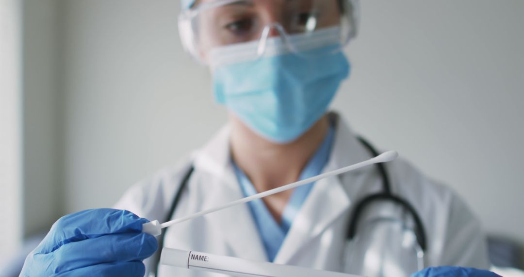 Healthcare Worker Holding Covid-19 Test Swab in Laboratory - Free Images, Stock Photos and Pictures on Pikwizard.com