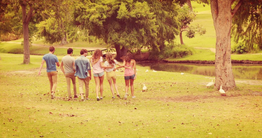 Group of Teens Relaxing and Walking in Park Near Pond - Free Images, Stock Photos and Pictures on Pikwizard.com