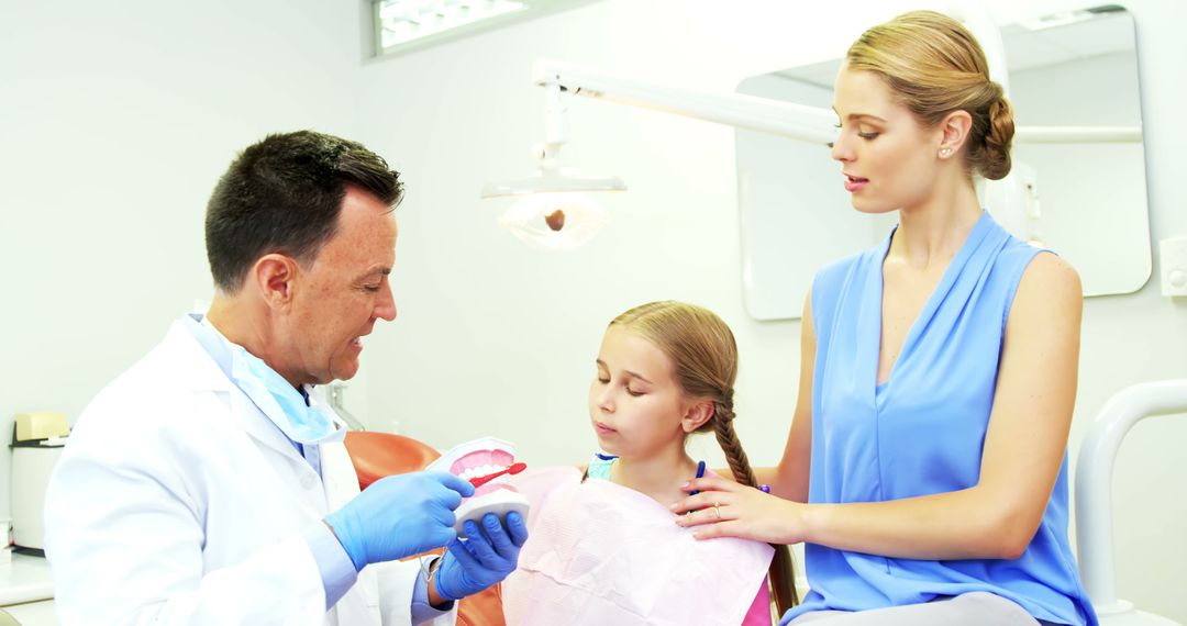 Female Child and Mother Consulting Dentist in Dental Clinic - Free Images, Stock Photos and Pictures on Pikwizard.com