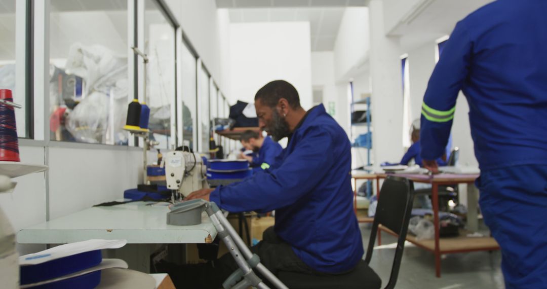 Workers Sewing Clothes in Busy Factory Setting - Free Images, Stock Photos and Pictures on Pikwizard.com