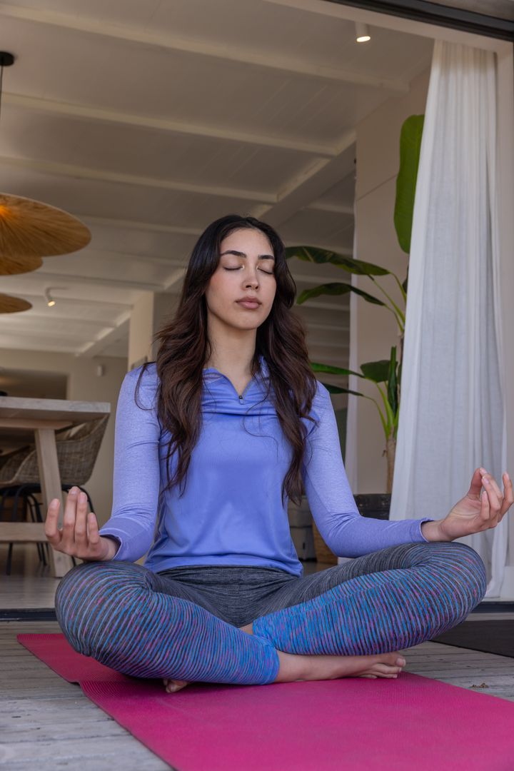 Woman Practicing Meditation on Deck in Serenity