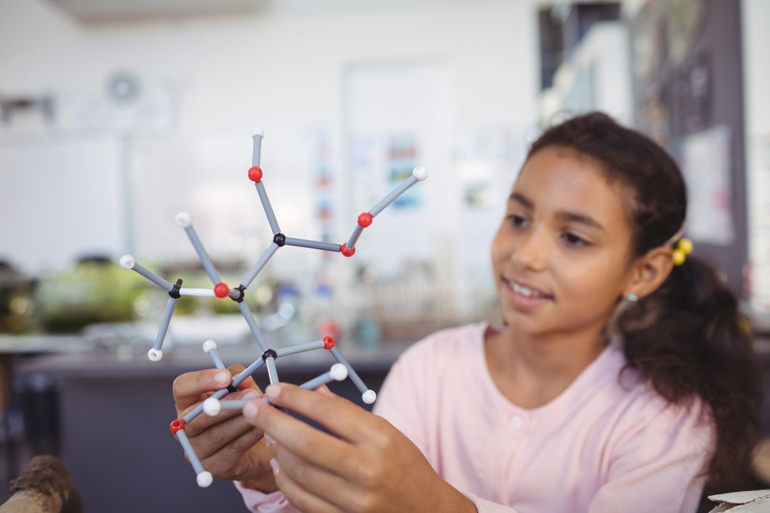 Elementary student holding molecule model - Free Images, Stock Photos and Pictures on Pikwizard.com