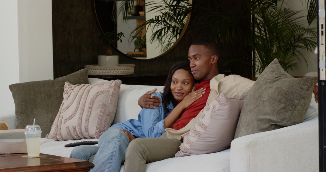 Couple Relaxing on Cozy Sofa Sharing Intimate Moment