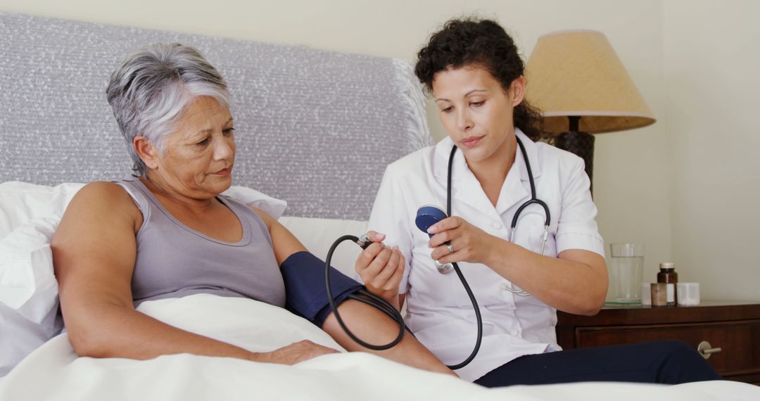 Home Visit Doctor Measuring Senior Woman's Blood Pressure in Bed - Free Images, Stock Photos and Pictures on Pikwizard.com