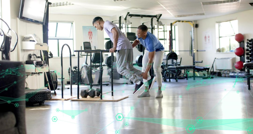 Trainer assisting client on parallel bars during assisted dip for strength and balance