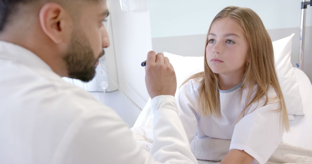 Doctor Examining Young Girl in Hospital Bed - Free Images, Stock Photos and Pictures on Pikwizard.com