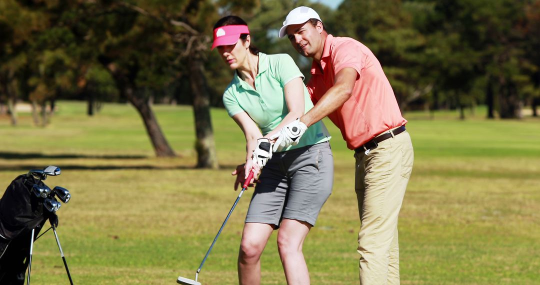 Golf Instructor Teaching Woman at Golf Course