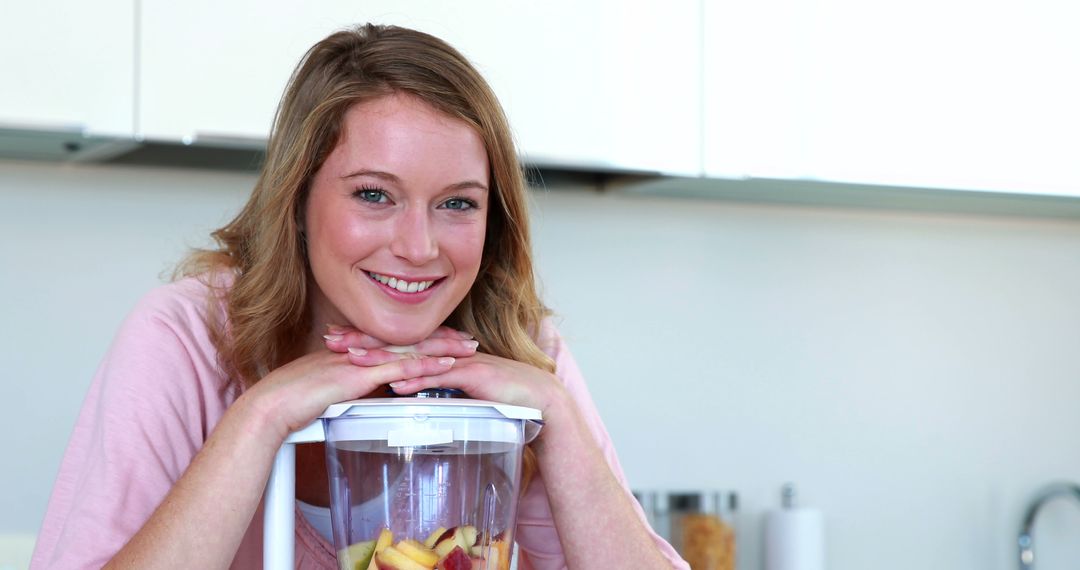 Smiling Woman Making Smoothie in Modern Kitchen - Free Images, Stock Photos and Pictures on Pikwizard.com